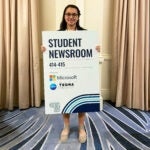 Casey Chan-Smutko poses with an ONA Student Newsroom sign