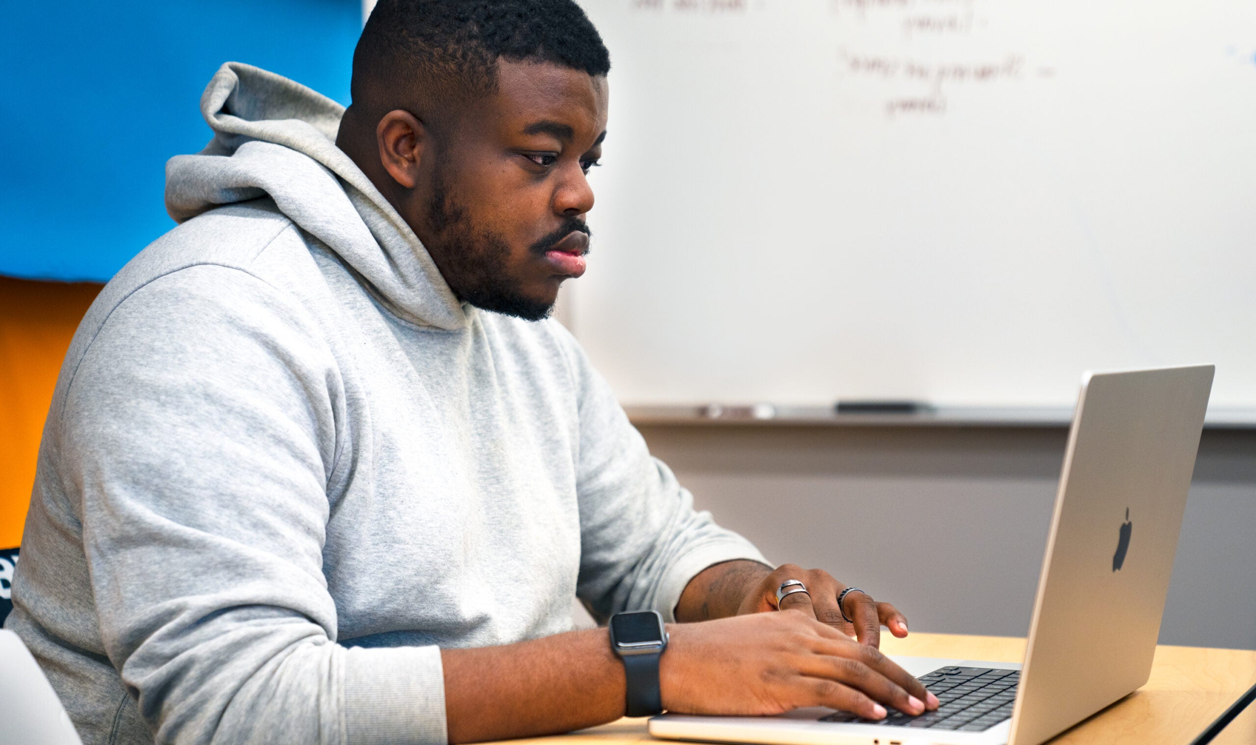 Student on a computer in the Harrington School Social Media Agency