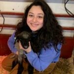 A photo of Maya Sophia Galeano holding a lamb