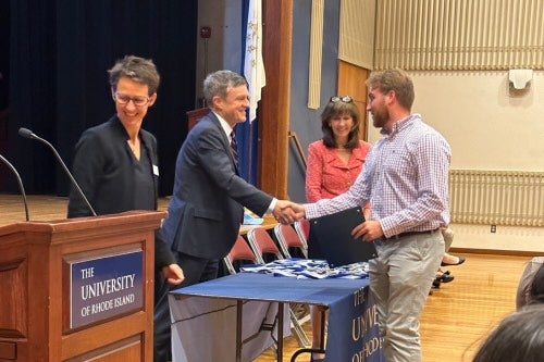 Student receives medal and certificate from President Parlange at Honors Ceremony