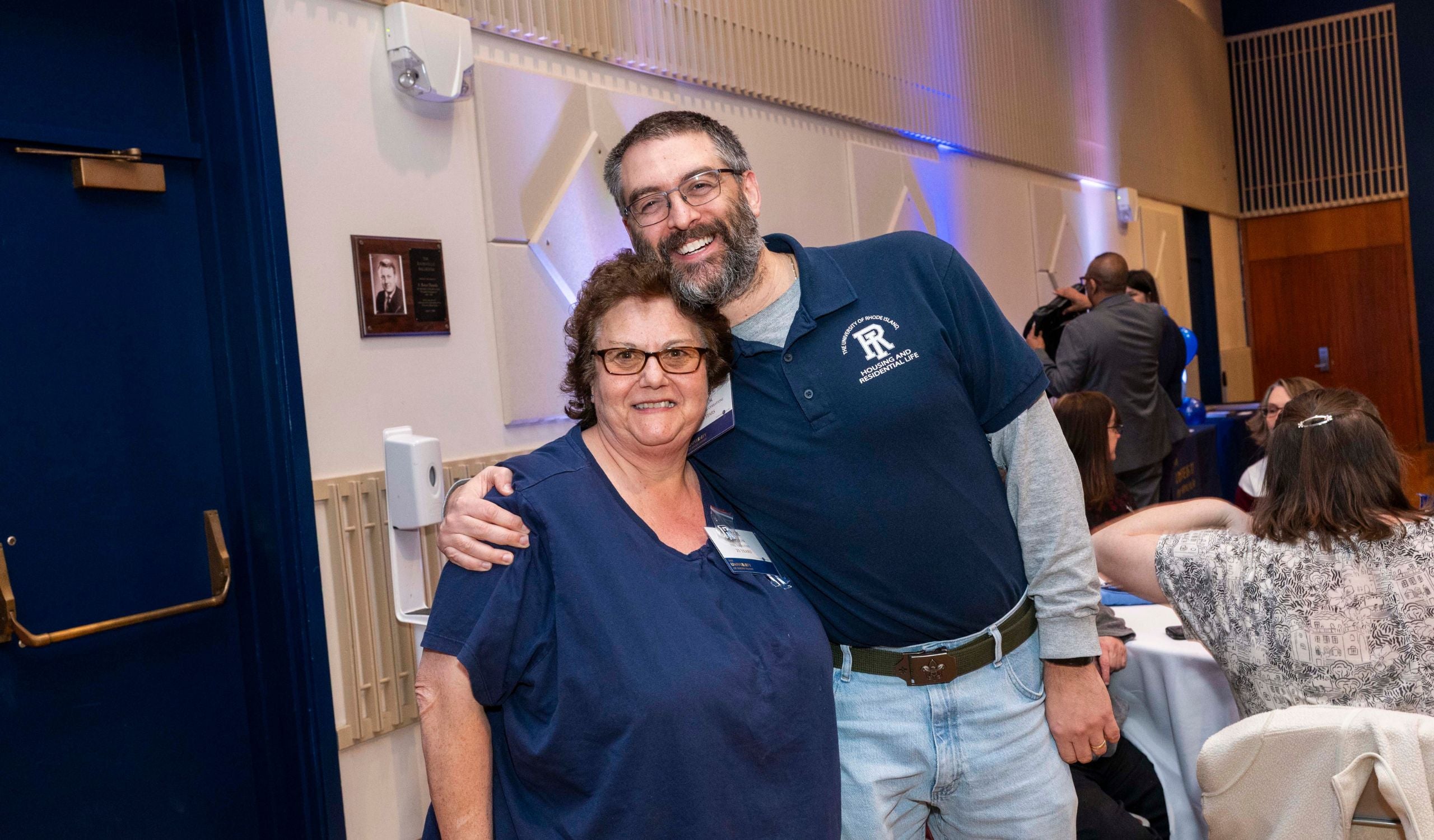 two employees smiling