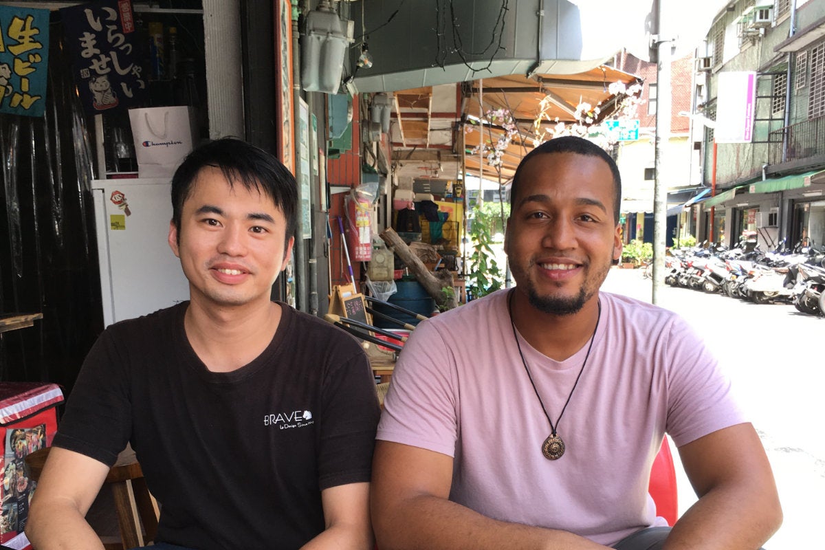 Two students sitting in a street side cafe in China