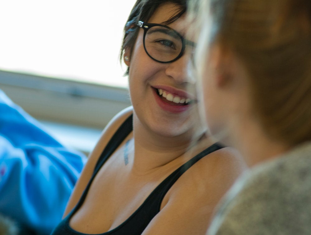 Students share a laugh during a Spanish language conversation hour