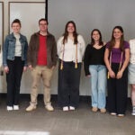 Kirsten Quay, Jordan Saris-Baglama, Morgan Beck, Dr. Mark Comerford (PME Faculty Adviser), Margot Paynter, Emily Upton, Jordan Medeiros, Abigail Orlando, and Dr. Irma Stevens, faculty presenter, stand together smiling for a photo.