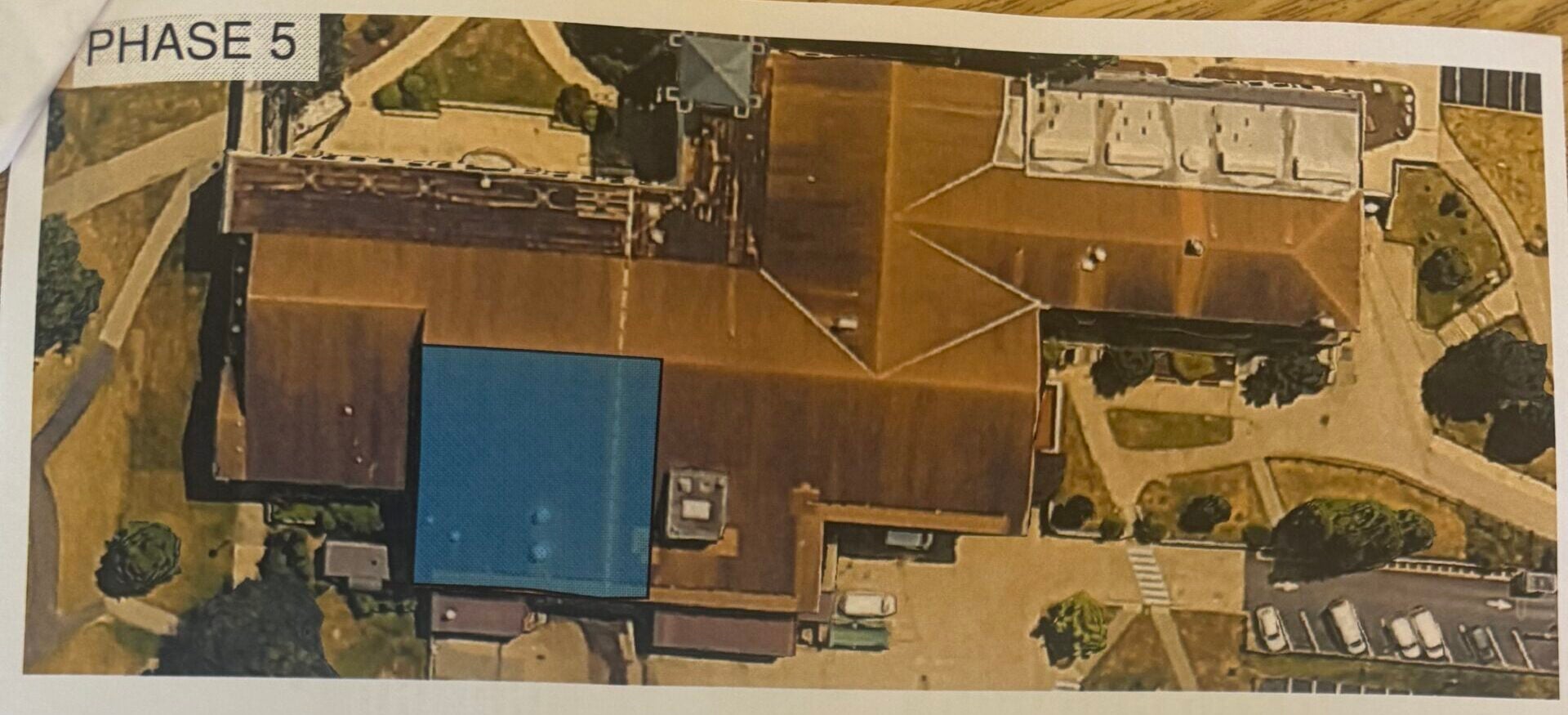 Aerial map of the Memorial Union showing the Phase 5 roof replacement work area, along with typical caution signage stating that affected doors are for emergency egress only during roof work.