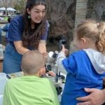 Kids looking at plankton under a microscope.