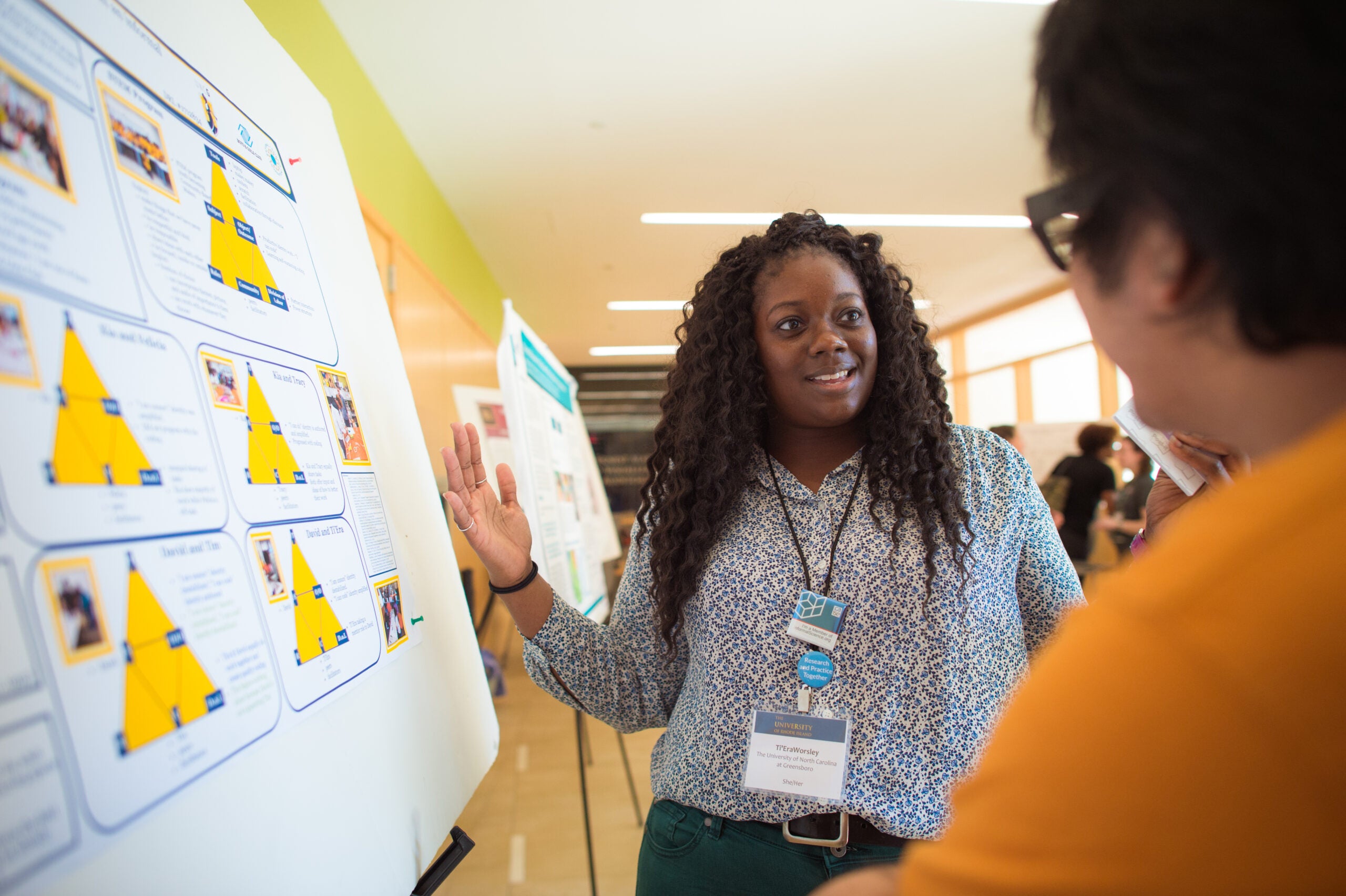 Woman in front of poster session at Inclusive SciComm Symposium