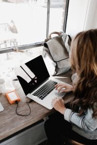 The back of women's head working on a laptop