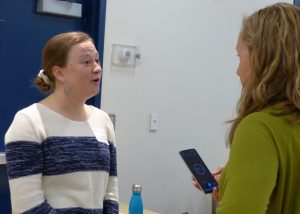 A woman talking to another women with excitement