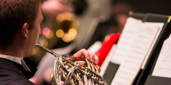 student playing french horn