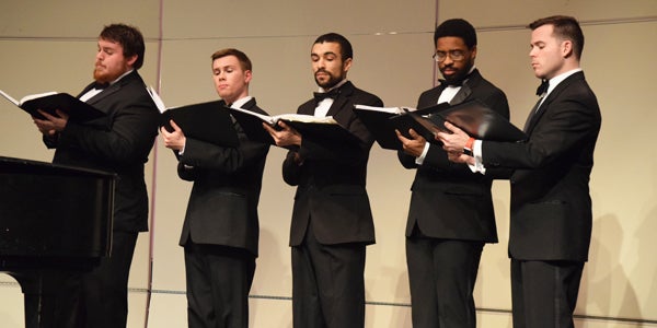 male vocal group singing onstage