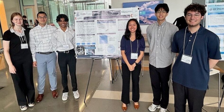 Six young people stand in front of a scientific research poster.