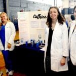 URI nursing students Emma Lee and Rebecca Lyman join nutrition student Samantha Dibiasio and pharmacy student Rachel Kelly at a wellness fair at South Kingstown High School.