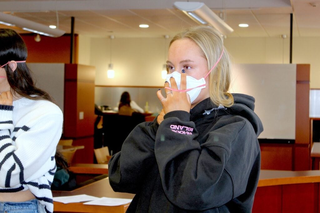 URI College of Nursing student Ava Fluddy is fit for an N-95 mask ahead of her clinical rotation at Westerly Hospital.