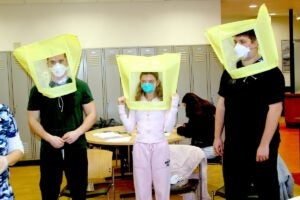 URI nursing students are fit-tested for N-95 masks before their clinical rotations. A head covering helps concentrate a bitter-tasting, non-toxic substance that is sprayed under the covering. If the students can not smell or taste the spray, the mask is a perfect fit.