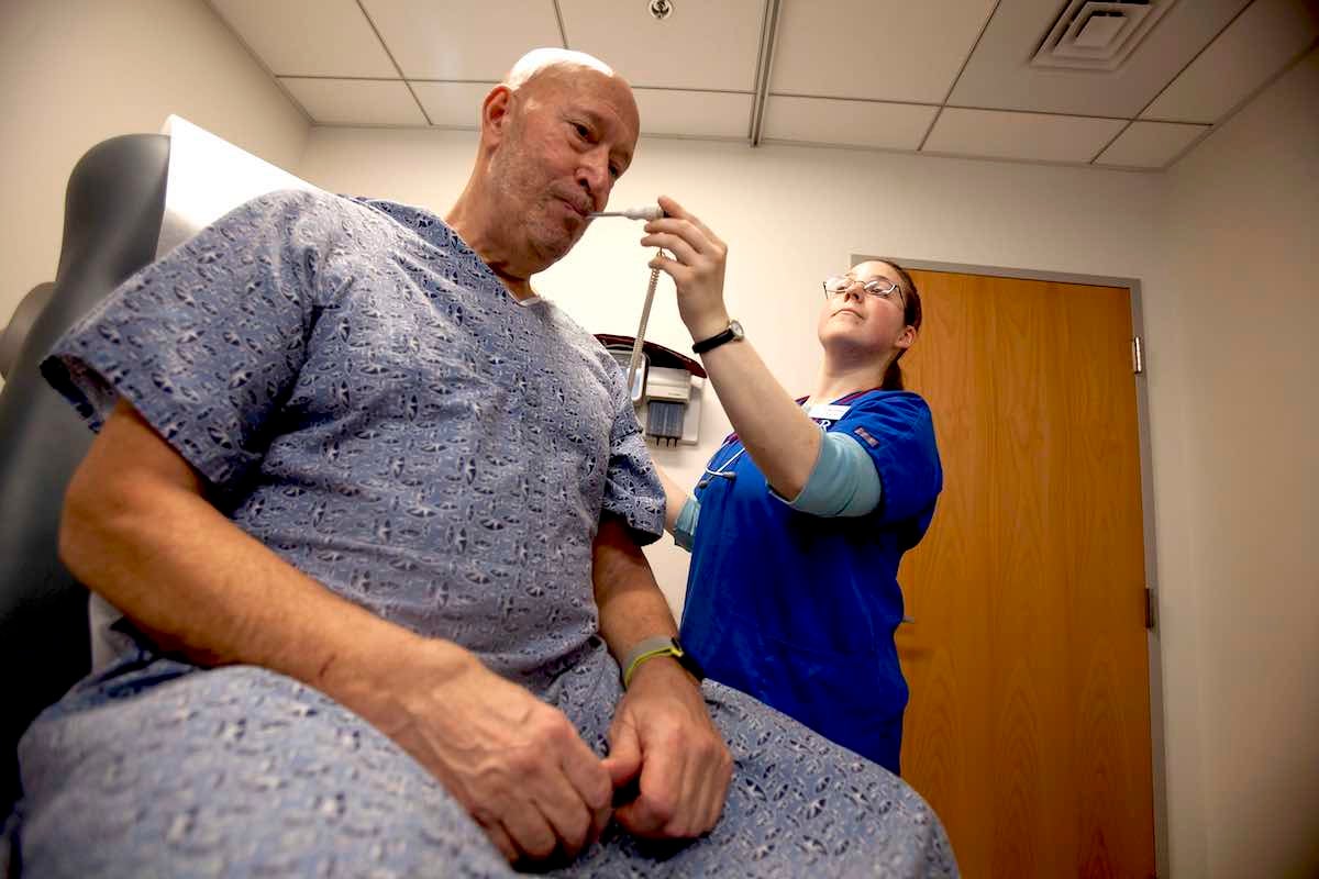URI College of Nursing student Kristen Schaffer examines a patient during a simulated health care team exercise.