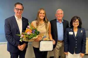 URI nusing student Alexis Melanson is pictured with Dean Danny Willis, Flyn Foundation founder and President Fred Flynn, and HopeHealth President and CEO Diana Franchitto at Melanson's graduation from the Susan D. Flynn Palliative Care Undergraduate Fellowship.