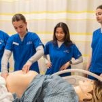 University of Rhode Island College of Nursing undergraduate students work in one of the advanced simulation labs at the Nursing Education Center in Providence.