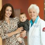 URI Nursing Professor Debra Erickson-Owens, right, with Shoi Parker and her little boy Cameron at Women & Infants Hospital. Cameron participated in the study of delayed cord clamping with full-term infants. URI photo