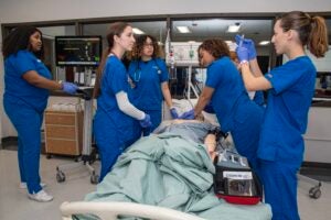 URI nursing students practice a code on a lifelike mannequin in the colleges simulation lab in White Hall on the Kingston Campus.