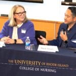 Gay Landstrom, left, and Rayne Soriano discuss caring science during the annual URI College of Nursing Spring Distinguished Lecture.