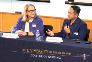 Gay Landstrom, left, and Rayne Soriano discuss caring science during the annual URI College of Nursing Spring Distinguished Lecture.