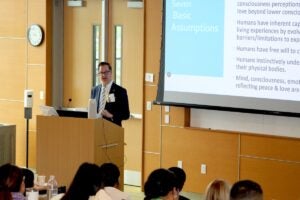 URI College of Nursing Dean Danny Willis delivers the keynote address as the college hosted the International Association for Human Caring 2025 annual conference June 26-28.