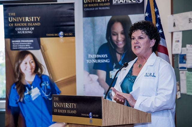 Nursing faculty member standing at press conference podium