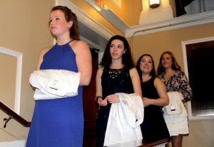 Students Casey Rockwood (left) Sabrina Rodriguez-Gervais, Madison Smith and Gigi Spadafore wait their turn to wear the white coats.