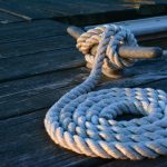 a large white rope tied to a dock