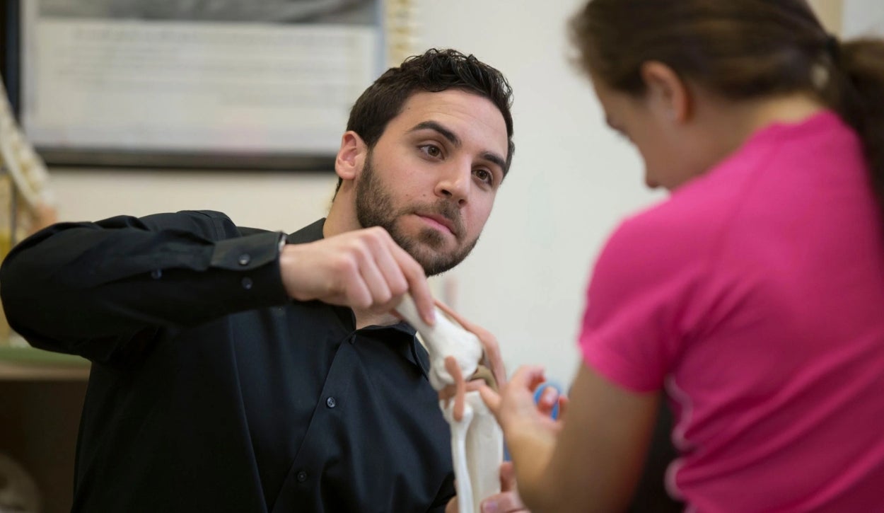 A health educator is speaking to a student.