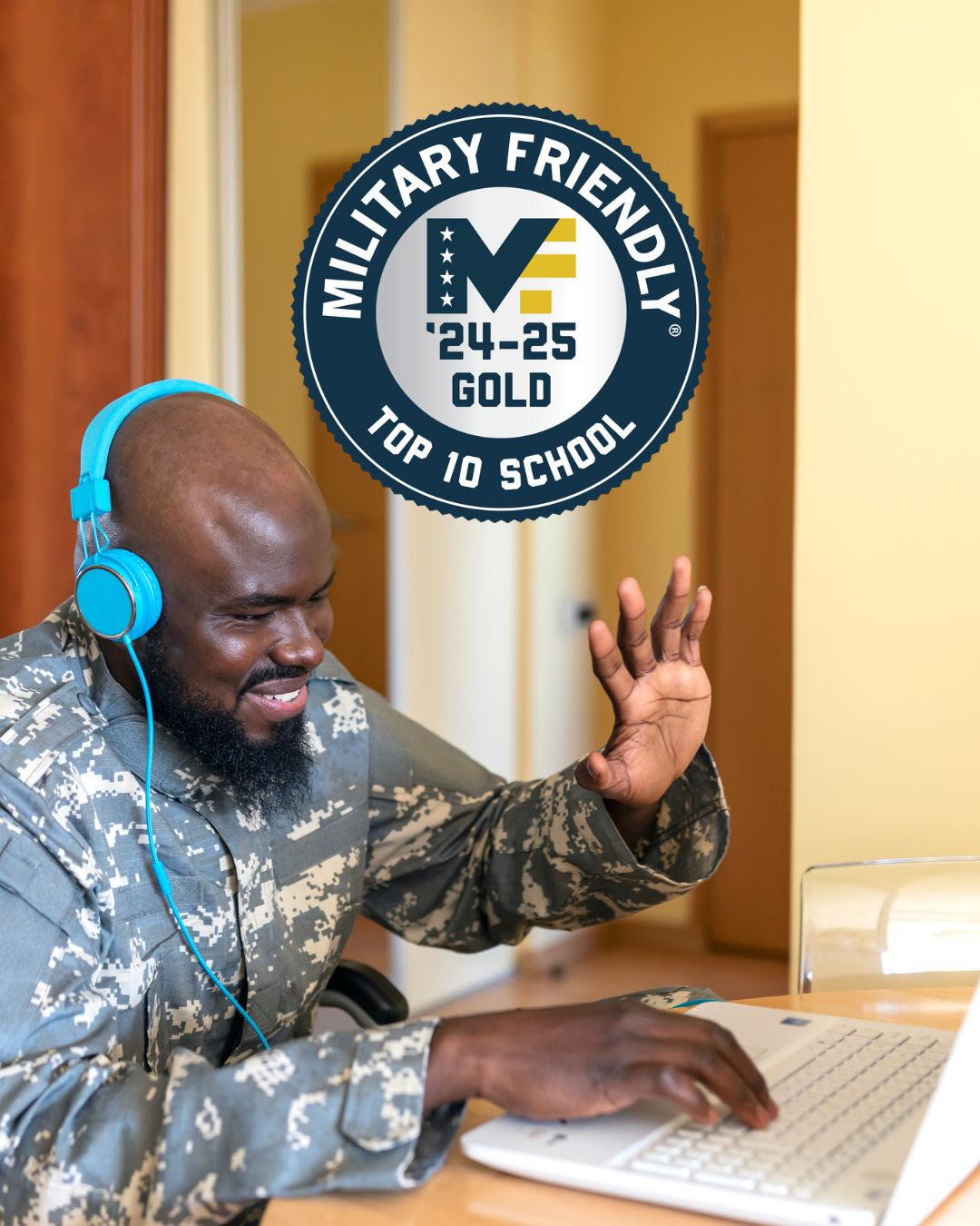 A young African-American veteran waves to someone on his computer during a virtual call.