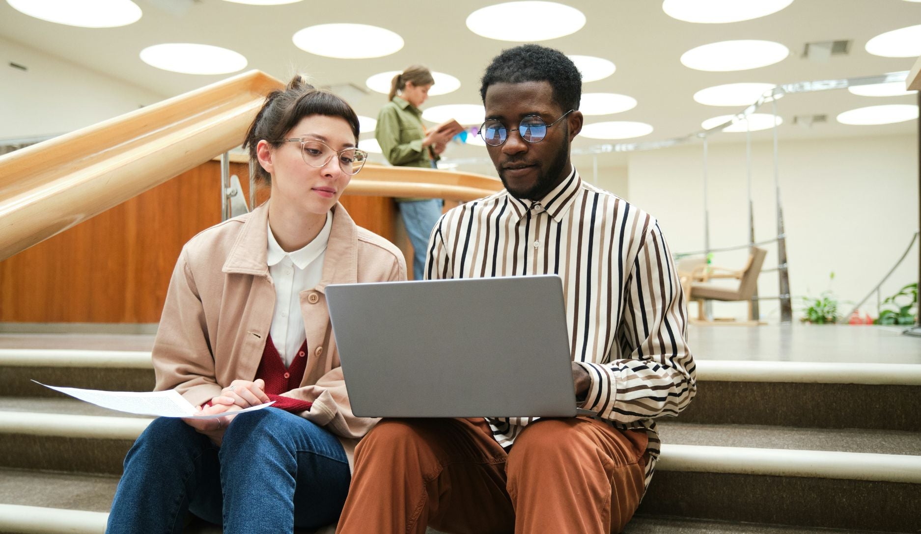 Two students working on a laptop.