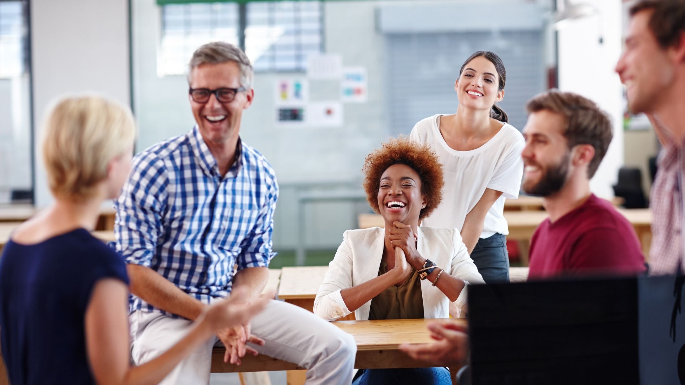 a diverse group of professionals engage in cheerful conversation