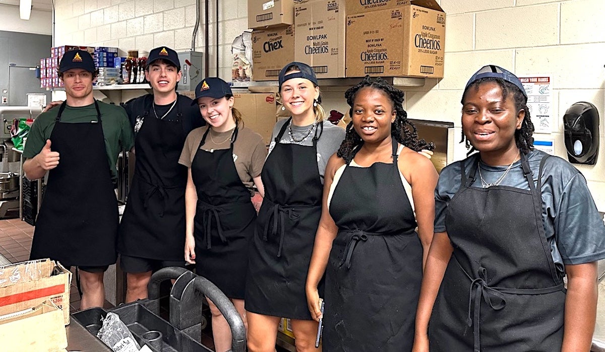 URI nutrition students work in the kitchen at Camp JORI in South Kingstown, site of Camp Surefire, a week-long summer camp for children living with Type 1 diabetes.