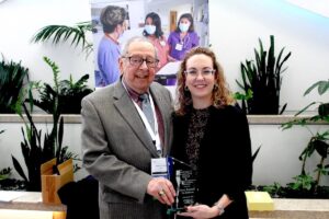 Emeritus Professor Norman Campbell presents the Norman A. Campbell Award for Ethics & Excellence in Healthcare to Stacey Ranucci during the college's annual Seminar By the Sea continuing education conference.