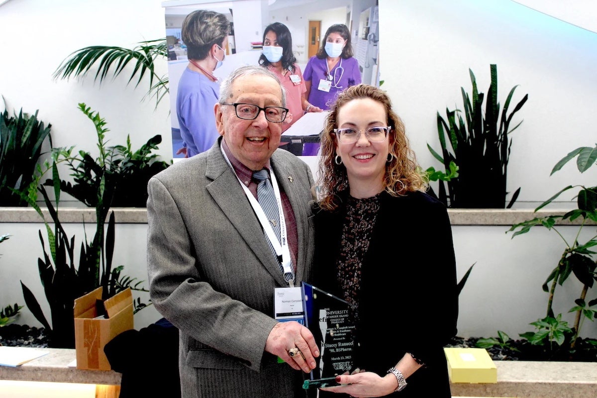 Emeritus Professor Norman Campbell presents the Norman A. Campbell Award for Ethics & Excellence in Healthcare to Stacey Ranucci during the college's annual Seminar By the Sea continuing education conference.