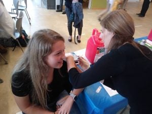 Pharmacy Professor Virginia Lemay, seen here administering a flu shot last year, will head up a meningitis B vaccination clinic and information campaign.