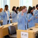 URI College of Pharmacy students take the Oath of a Scientist during a recent Lab Coat Ceremony, which marks their transition into laboratory research in the colleges Biomedical and Pharmaceutical Sciences program.