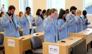 URI College of Pharmacy students take the Oath of a Scientist during a recent Lab Coat Ceremony, which marks their transition into laboratory research in the colleges Biomedical and Pharmaceutical Sciences program.