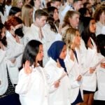 URI College of Pharmacy students take the Oath of a Pharmacist for the first time on Sept. 26 as they are welcomed into the profession during the college's annual White Coat Ceremony.