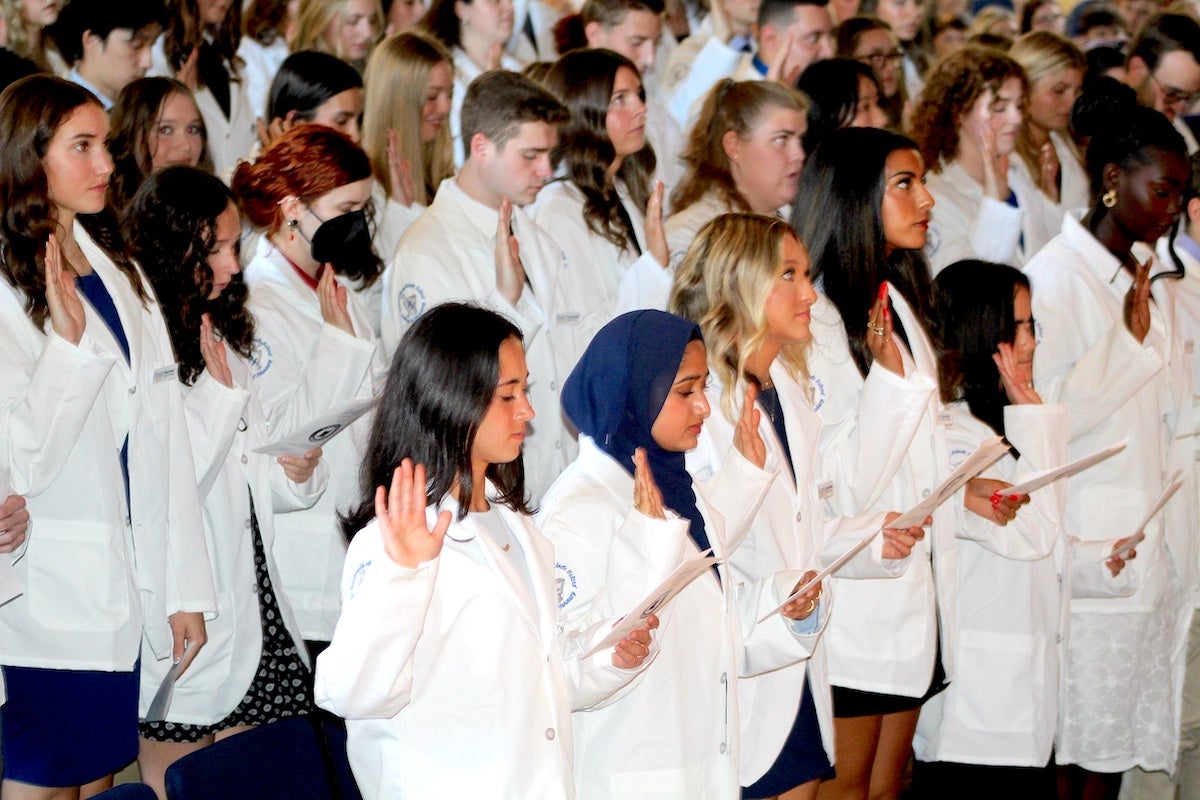 URI College of Pharmacy students take the Oath of a Pharmacist for the first time on Sept. 26 as they are welcomed into the profession during the college's annual White Coat Ceremony.