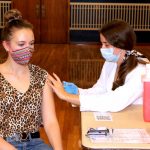 P3 student Madelyn Day vaccinates student Lily Bogdanowicz.
