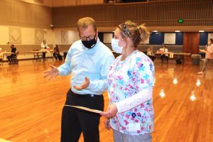 College of Pharmacy Clinical Professor Jeffrey Bratberg meets with URI Health Services nurse Lisa Alofsin during a flu clinic in the Memorial Union ballroom Nov. 9.