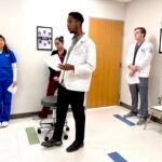 URI College of Pharmacy student Shakir Pike joins URI nursing and physical therapy students, along with a medical student from Brown University in assessing a patient case during an Interprofessional Education Program at Brown's Warren Alpert Medical School.