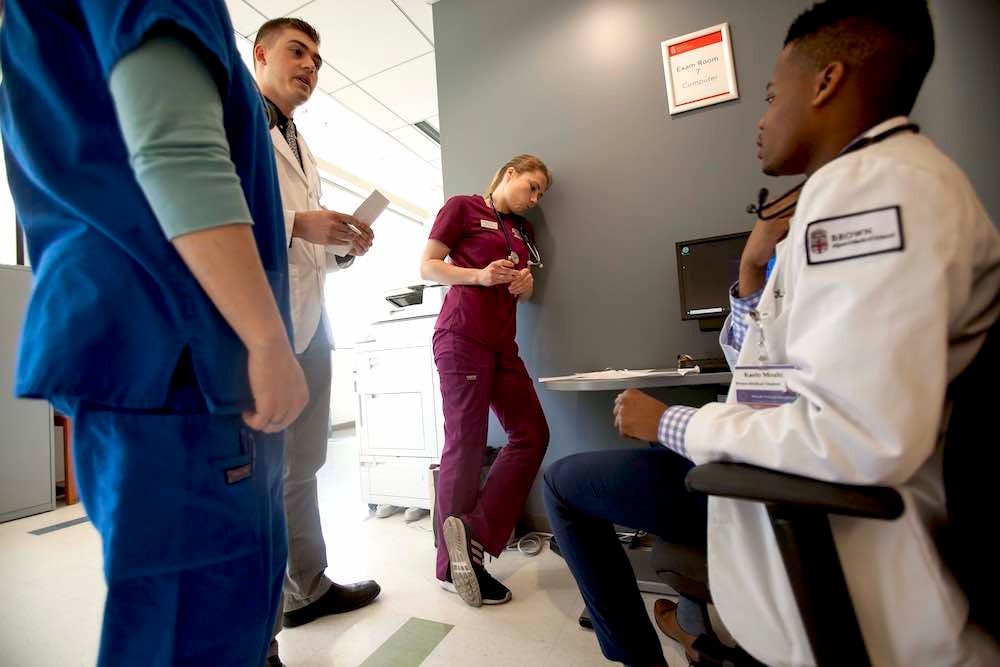 URI Pharmacy student Matthew Lefebvre works with other health care professionals during a simulated team event.