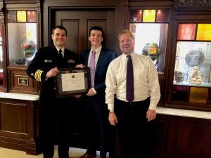 Graduating PharmD student Michael Burkett is pictured with Capt. Bill Leahult and Clinical Professor Jeffrey Bratberg.