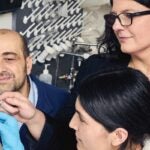 Pharmacy and neuroscience Professors Jaime Ross (right) and Giuseppe Coppotelli observe a cryosectioned brain slice alongside Ph.D. student Sajida Bibi.