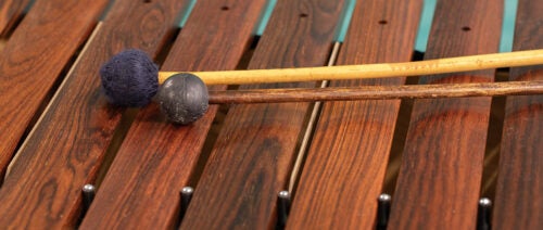 A pair of mallets rest atop a xylophone 