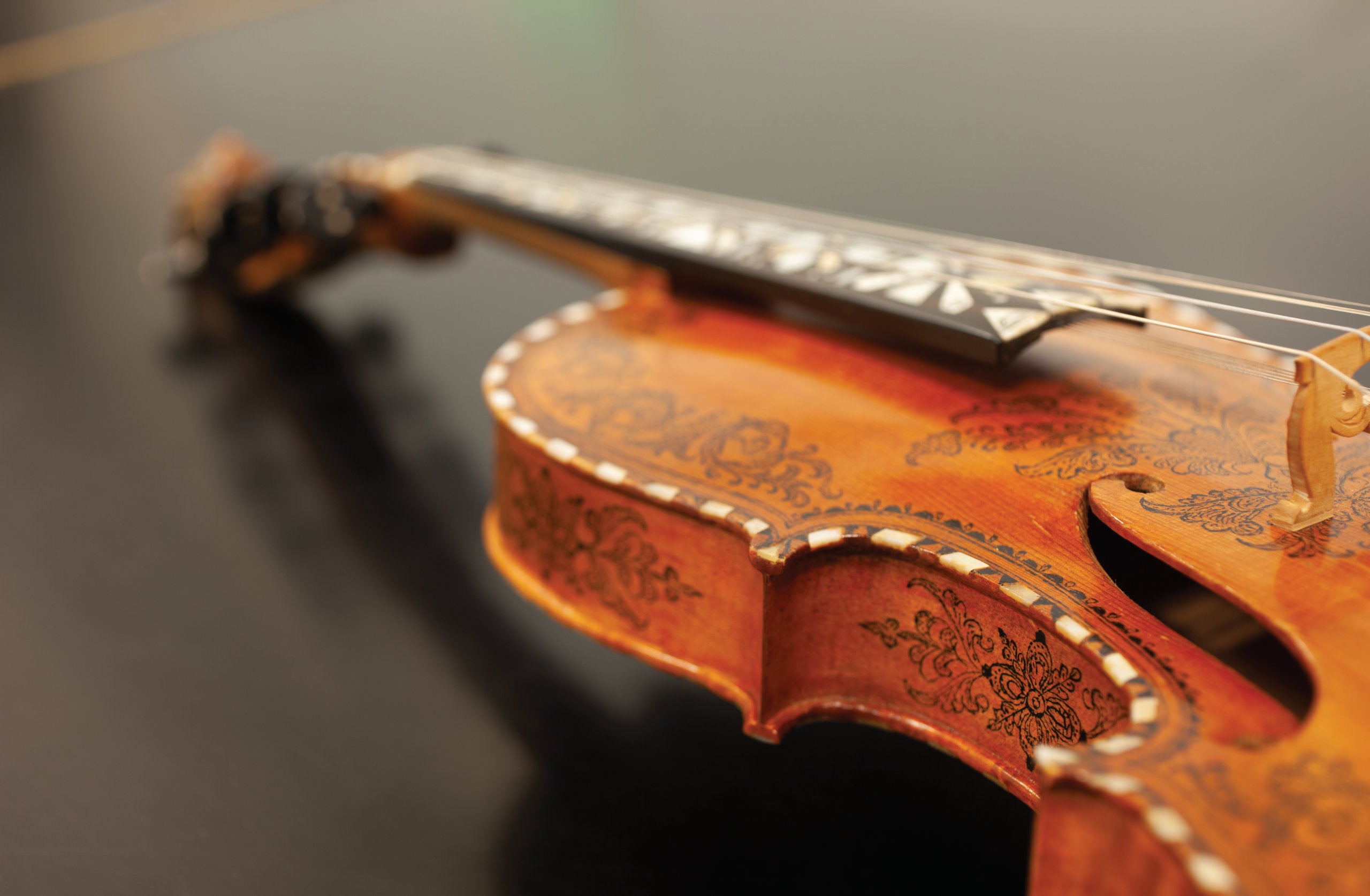 A close-up shot of violin with intricate wooden inlay